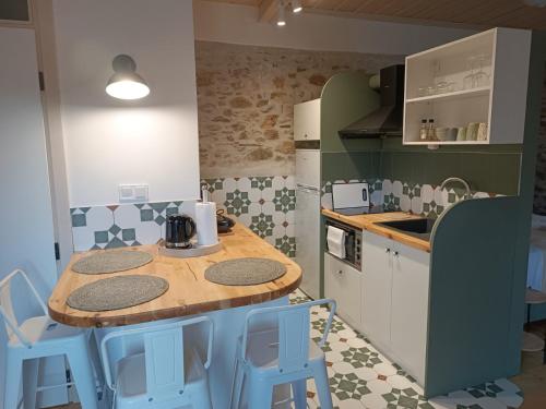 a kitchen with a wooden table and some blue stools at Casa Lehovo in Lechovo