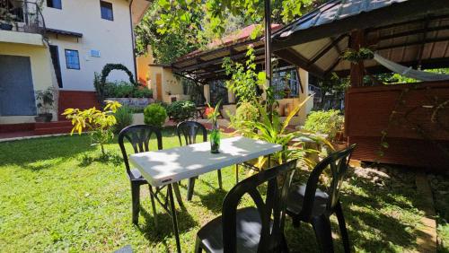 a table and chairs in the yard of a house at Eagles Nest Beach Resort in Davao City