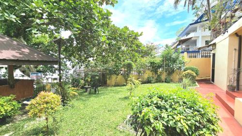 a backyard with a yard with plants and trees at Eagles Nest Beach Resort in Davao City