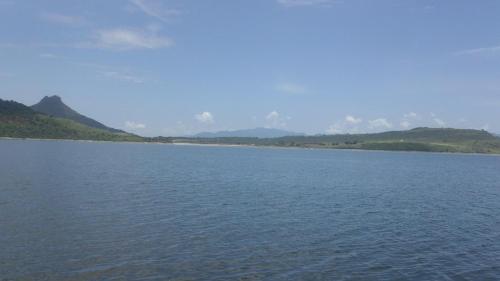 a large body of water with mountains in the background at Hotel Villa Monarca Inn in Zitácuaro