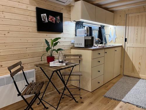 a small kitchen with a table and a chair at Ezy House in Ézy-sur-Eure