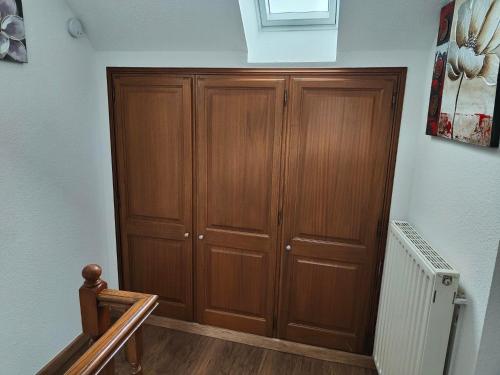 a large wooden cabinet in a room with stairs at GÎTE DE LA FONTAINE in Wangen