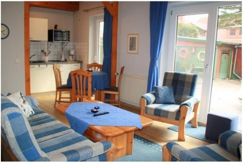 FeWo Waldkauz - Ulenhoef في بريرو: غرفة معيشة مع أريكة وكراسي وطاولة