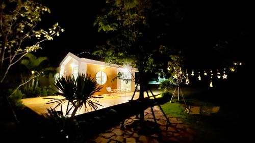 a house lit up at night with lights at บ้านไร่ฟ้าสวยวังน้ำเขียว Nordic 01 in Ban Kom