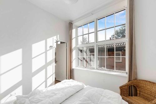 a bedroom with a bed and a large window at Lovely Apartment At Beautiful Solgaarden 9 in Svaneke