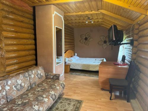 a living room with a couch and a bedroom at ЕЛІТ in Svalyava