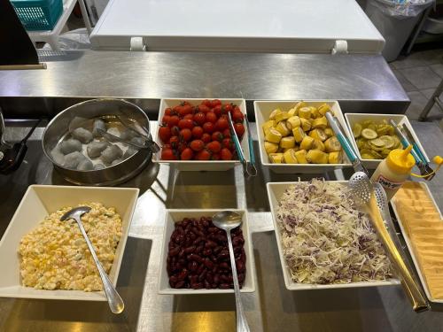 a buffet with several trays of different fruits and vegetables at BK Hotel Jeju in Seogwipo