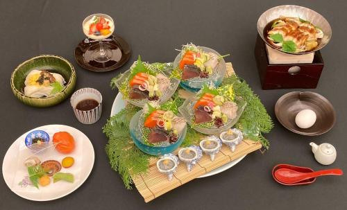 a table with a tray of food and plates of food at The Gran Resort Elegante Awajishima in Awaji