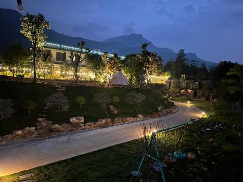 a view of a garden at night with a tent at King Bavi Resort in Ba Vì