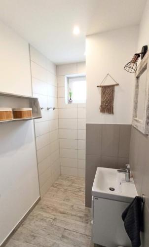 a small bathroom with a sink and a shower at Kwatera u Somsiada -Apartament in Muszyna