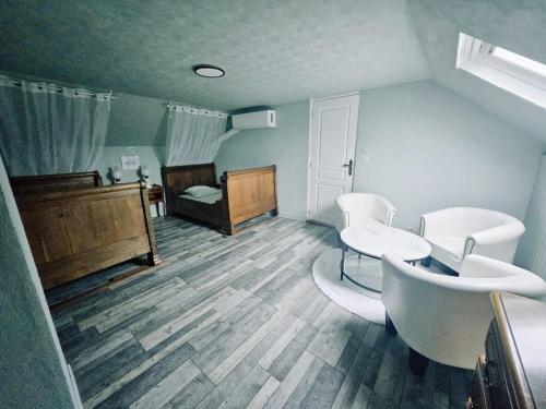 a bathroom with a sink and a table and a bed at Gîte de Montapeine 8 in Breteau