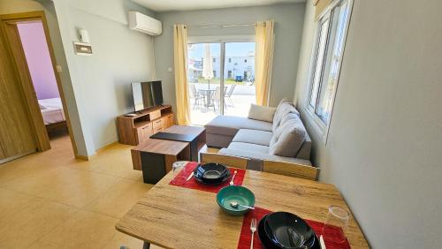 a living room with a couch and a table at Beach Love BeachFront Apartment in Pyla