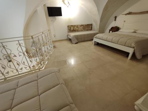 a living room with two beds and a staircase at B&B Punta Cutieri in Gallipoli