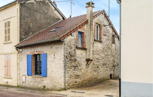 an old brick building with blue windows and a cross at Nice Home In Bayel With Wifi in Bayel