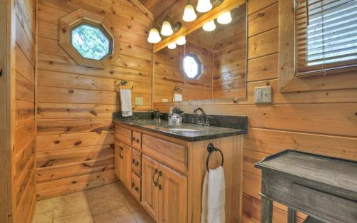 a bathroom with a sink in a log cabin at Appalachian Sunrise Amazing views Close to Blue Ridge hike from the cabin in Blue Ridge