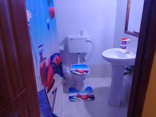 a bathroom with a toilet and a sink at Blessing Holiday Homes - Diani Beach in Diani Beach