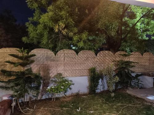 a brick fence with plants on top of it at Div's luxurious homestay in Jaipur