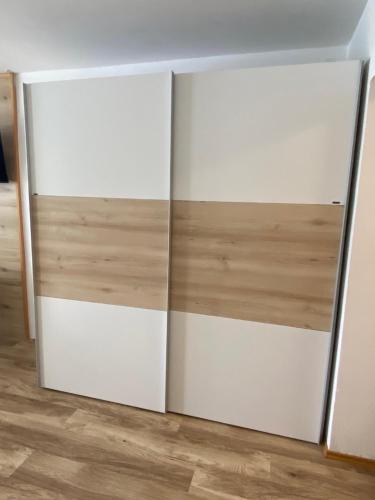 a pair of white closet doors in a room at Apartment mit Seeblick in Strobl