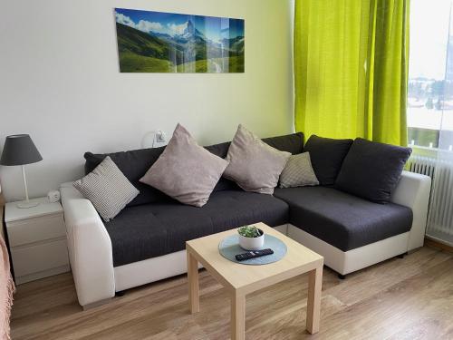 een woonkamer met een bank en een tafel bij Apartment mit Seeblick in Strobl