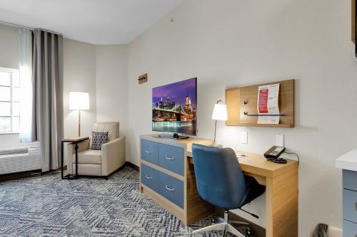 a hotel room with a desk and a chair at Candlewood Suites San Antonio Downtown by IHG in San Antonio
