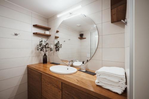 a bathroom with a sink and a mirror at Modern Apartment in the Heart of Kuressaare in Kuressaare