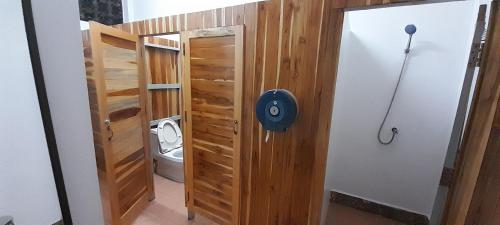 a bathroom with a toilet and a wooden wall at MK Hostel in Luang Prabang