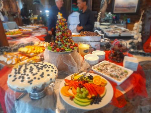 a buffet of food with a christmas tree on a table at Ditholo Game Lodge Bela Bela in Bela-Bela