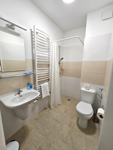 Łazienka z białą toaletą i umywalką w obiekcie Sanatorium Rehabilitacyjne im Janusza Korczaka w Krasnobrodzie