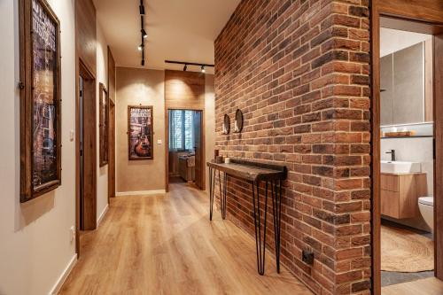 a brick wall in a bathroom with a fireplace at STING Residence Platan in Ostrava
