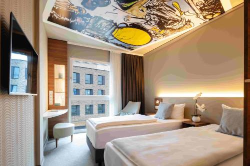 a hotel room with two beds and a painting on the ceiling at Hey Lou Hotel Monheim am Rhein in Monheim