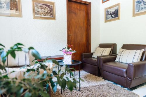 a living room with two couches and a table at Apartma Roner in Podbrdo