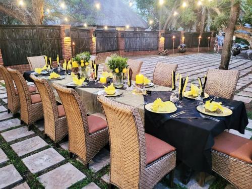 a table set up for a dinner party on a patio at Ditholo Game Lodge Bela Bela in Bela-Bela