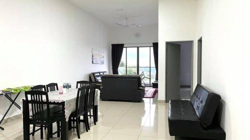 a living room with a table and chairs and a couch at Home Garden - Palas Horizon, Brinchang Cameron Highlands in Cameron Highlands