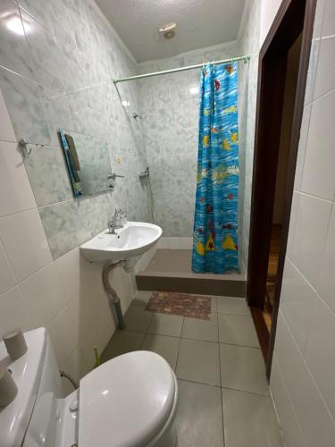 a bathroom with a toilet and a sink and a shower at ЕЛІТ in Svalyava