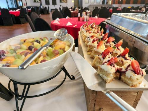 a table with a plate of food and a bowl of fruit at Safari Hotel & Convention Centre in Rustenburg