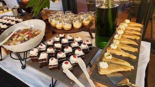 a table with a bunch of desserts on a table at Safari Hotel & Convention Centre in Rustenburg