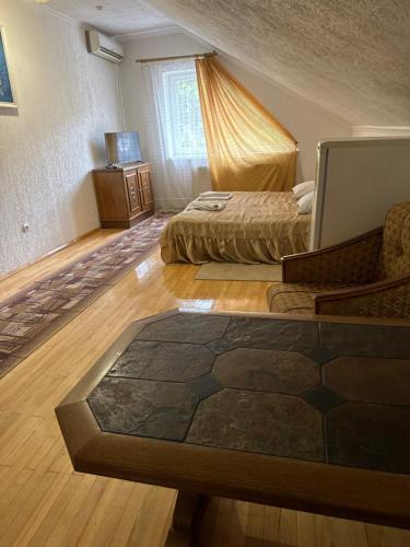 a bedroom with two beds and a television in it at ЕЛІТ in Svalyava
