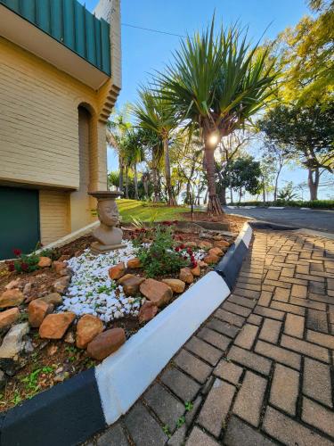 a rock garden in front of a house at Safari Hotel & Convention Centre in Rustenburg