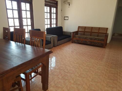 a living room with chairs and a table at Rajarata Villa Anuradhapura in Anuradhapura