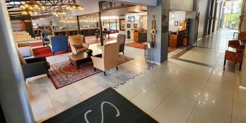 a lobby of a store with tables and chairs at Safari Hotel & Convention Centre in Rustenburg
