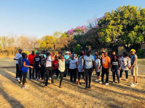 a group of people walking down a dirt road at Safari Hotel & Convention Centre in Rustenburg