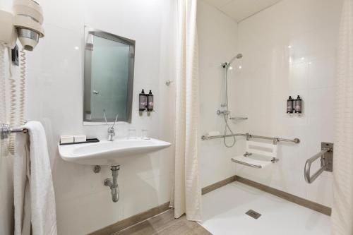 a white bathroom with a sink and a shower at Hotel Best 4 Barcelona in Barcelona