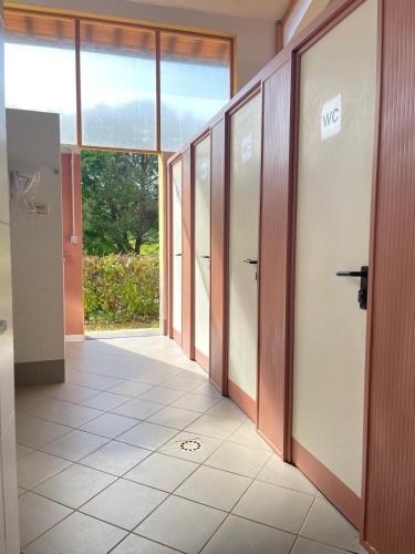 an empty hallway with doors in a building at Toscana Holiday Village in Montopoli in Val dʼArno