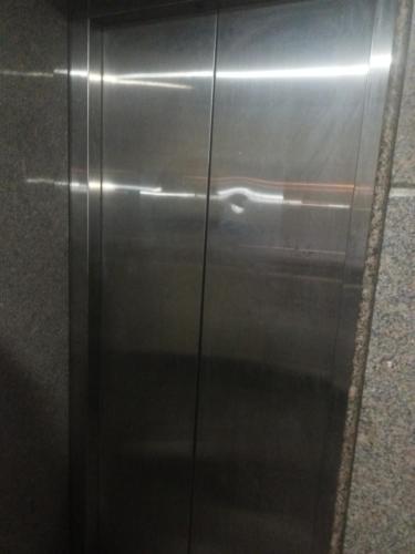 a stainless steel elevator in a train station at SkykingHotel in Sonīpat