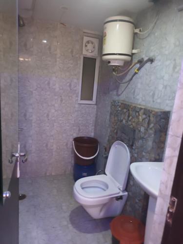 a bathroom with a toilet and a sink at SkykingHotel in Sonīpat