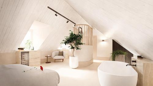 a living room with white furniture and a vaulted ceiling at Hotel de ABDIJ Dokkum in Dokkum