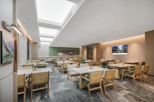 an empty dining room with tables and chairs at Atour Hotel Chongqing Liangjiang Happiness Plaza in Chongqing