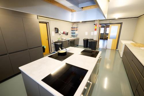 a large kitchen with a counter in a room at Karivollen Overnatting in Melhus
