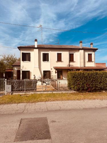 uma casa branca com uma cerca à frente. em Vila Romaneasca em Corbola