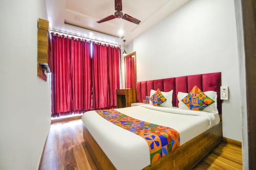 a bedroom with a large bed and a red window at FabExpress 56 Amritsar in Amritsar